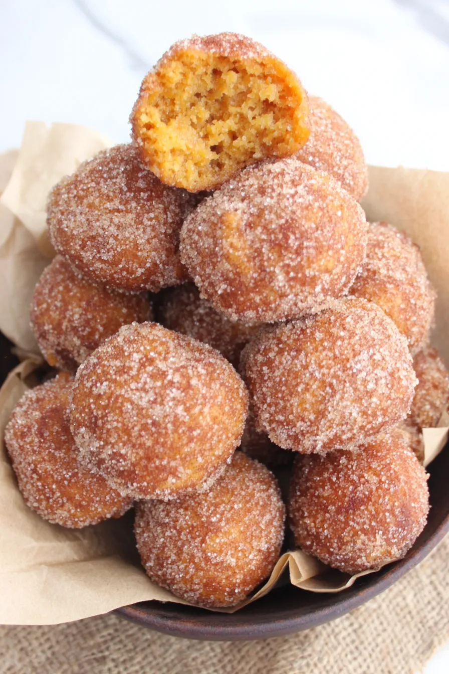 A close-up of a cinnamon sugar coated pumpkin donut hole
