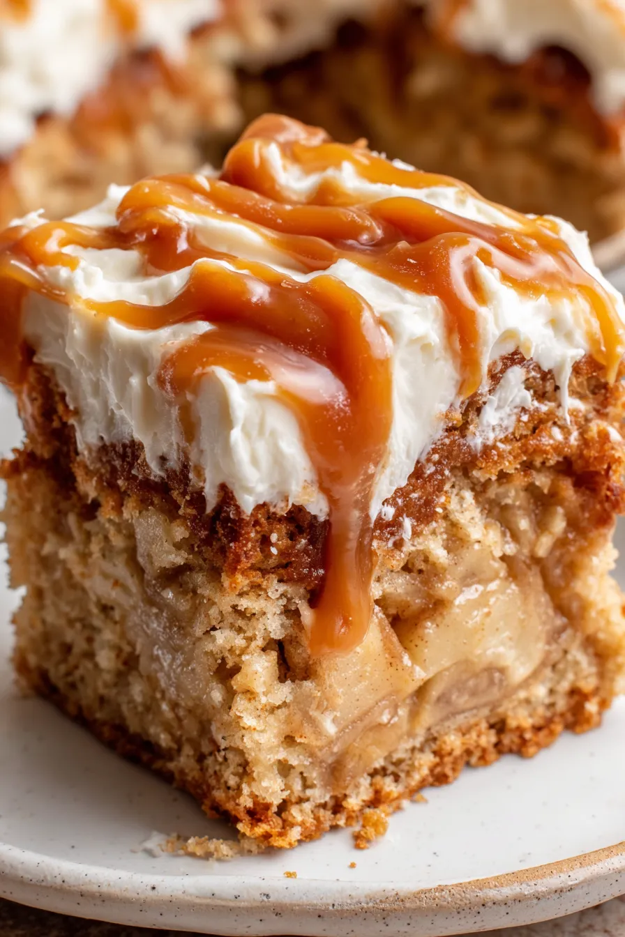 Sliced apple spice cake with frosting and caramel