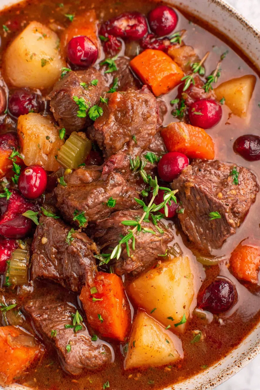 Bowl of cranberry apple beef stew garnished with parsley