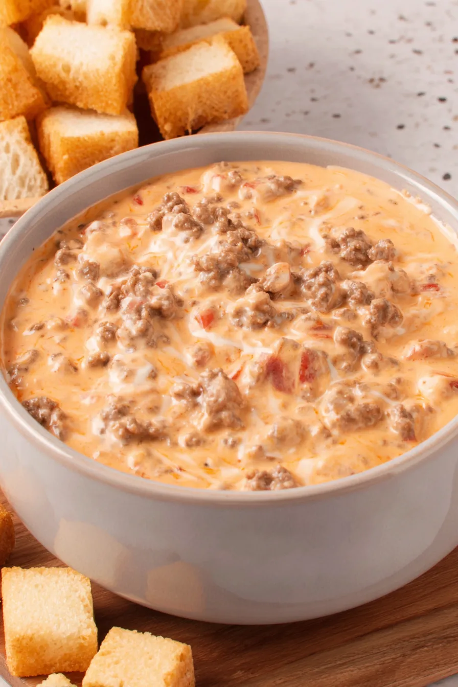 Served bowl of cheesy dip with chips