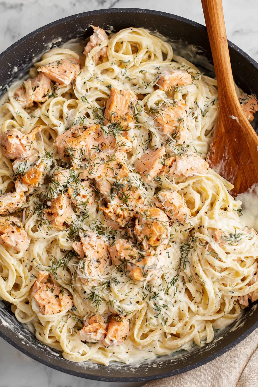 Pan-seared salmon with creamy lemon dill sauce served over pasta