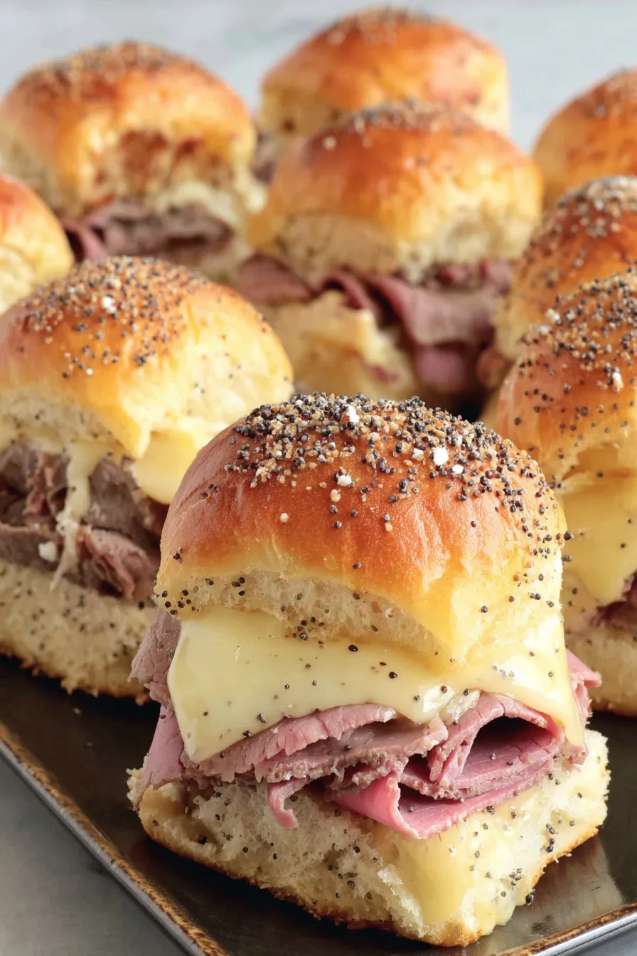 Close-up of a single roast beef slider with melted cheese