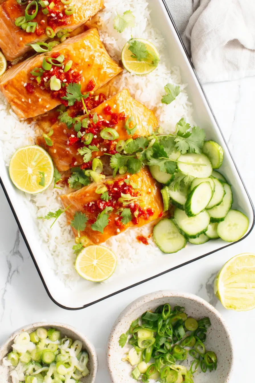 Salmon fillets glazed with sweet chili sauce on a baking sheet