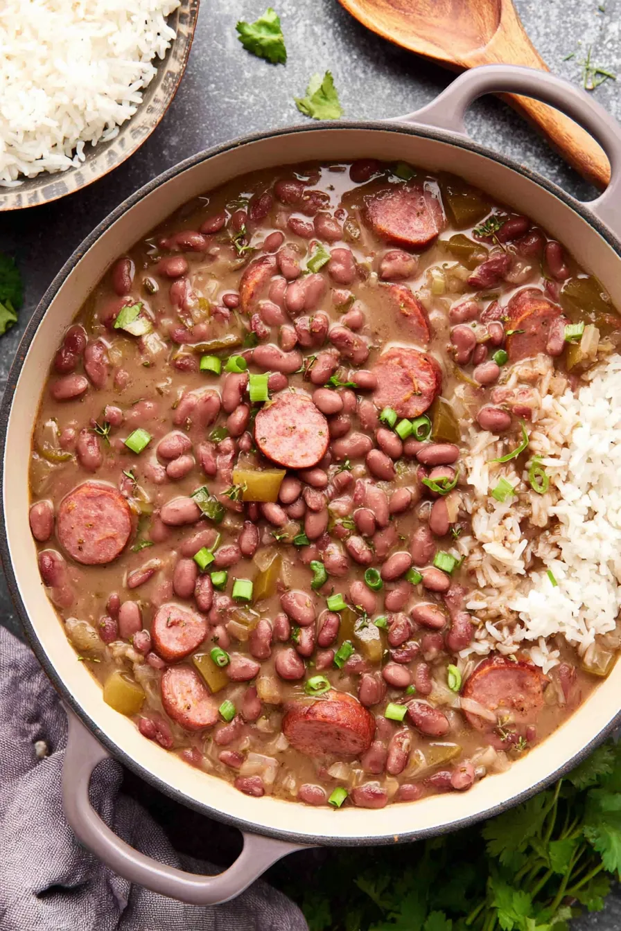 Bowl of red beans and rice topped with green onions