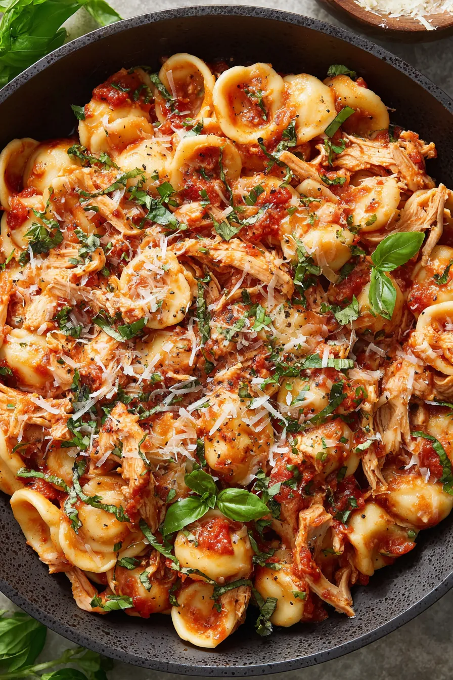 Orecchiette tossed with spicy tomato sauce in pot
