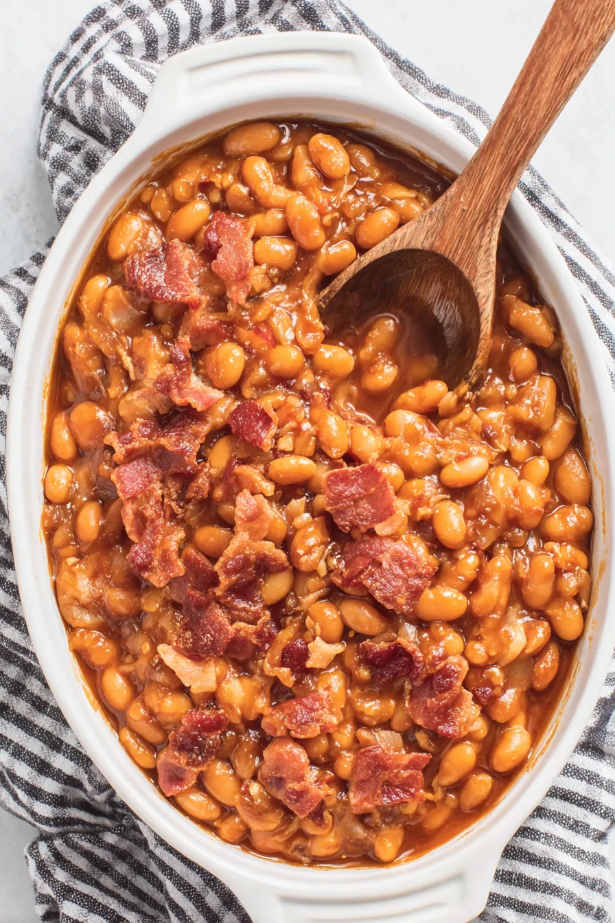 Finished tray of baked beans with bacon, glossy and bubbling