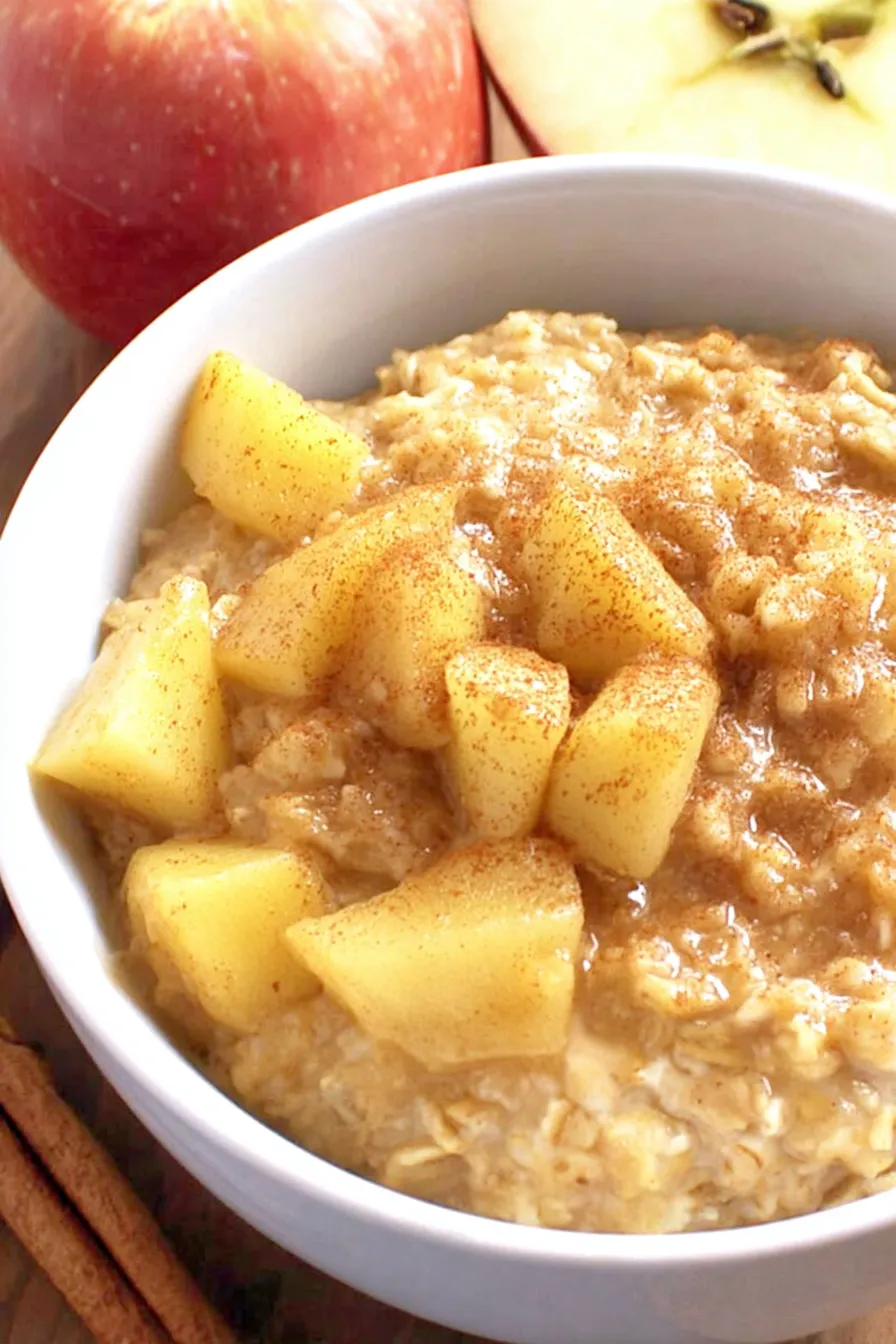 Bowl of apple cinnamon oatmeal topped with nuts