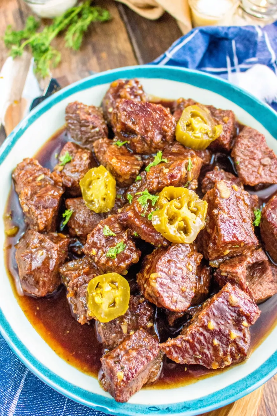 Seared steak bites in a skillet ready for slow cooker