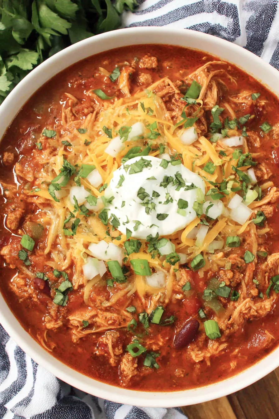 A bowl of leftover turkey chili with toppings