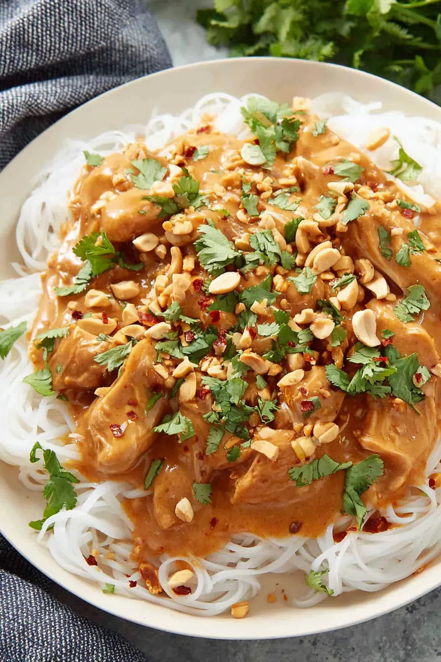 Plated Thai peanut chicken served with rice and cilantro garnish