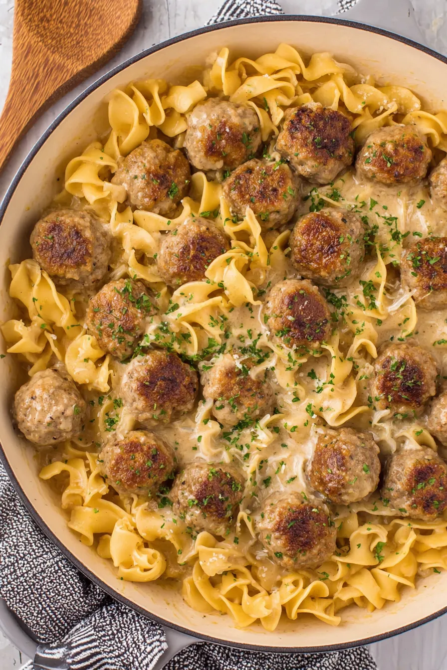 Meatballs simmering in creamy sauce
