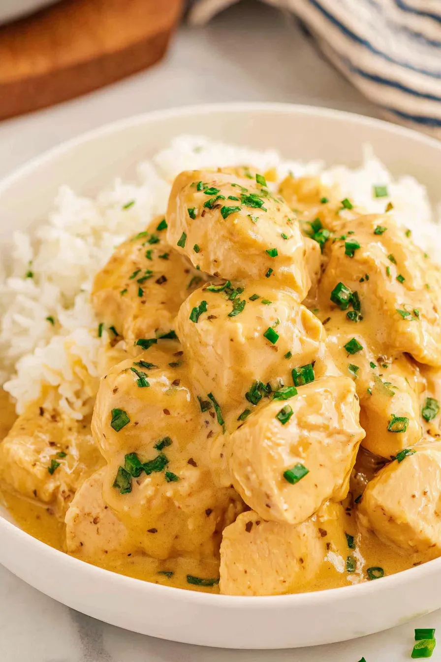 Served chicken and gravy over mashed potatoes with green onions on top