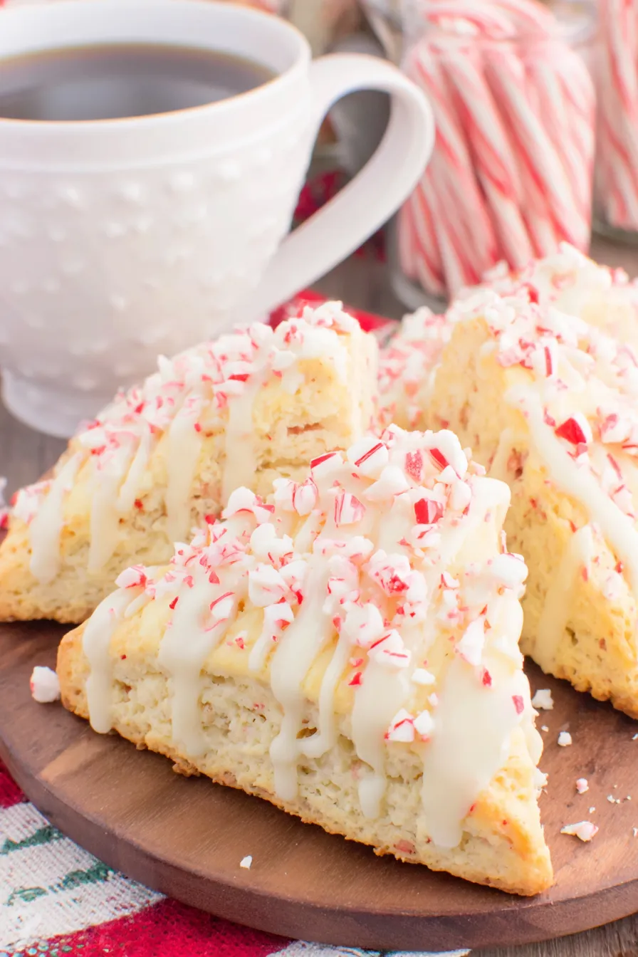 Close up of a scone wedge with white chocolate glaze and crushed candy cane