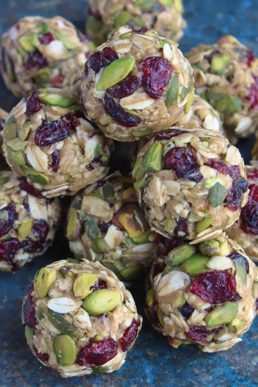 Cranberry pistachio energy bites on a wooden board