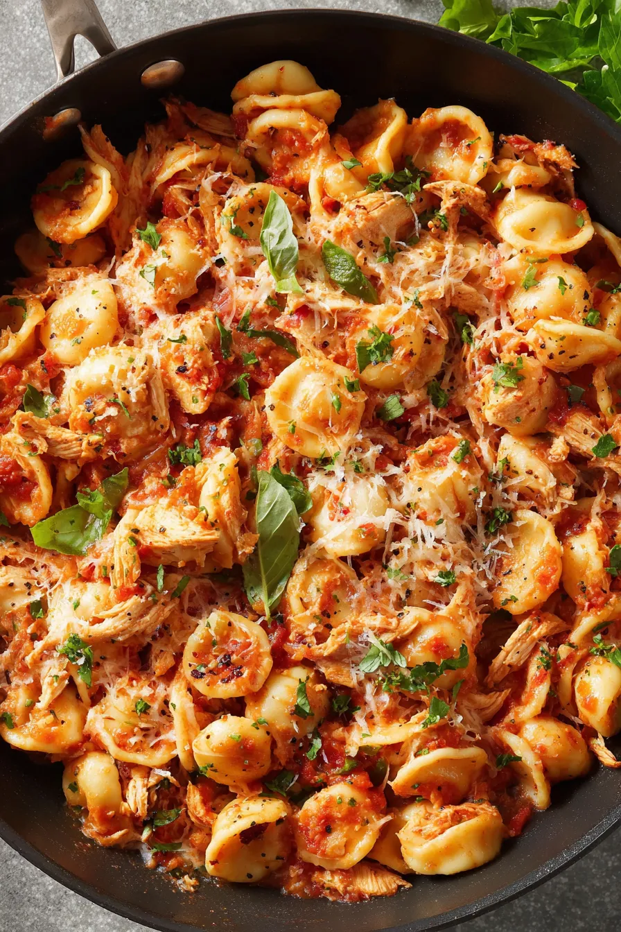 Serving Chicken Fra Diavolo on plate with parmesan