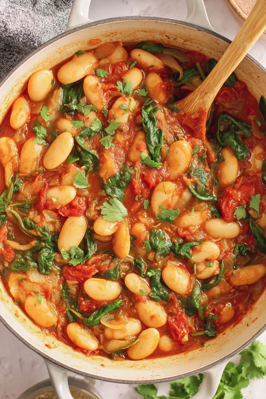 Bowl of butter bean stew with cilantro and bread