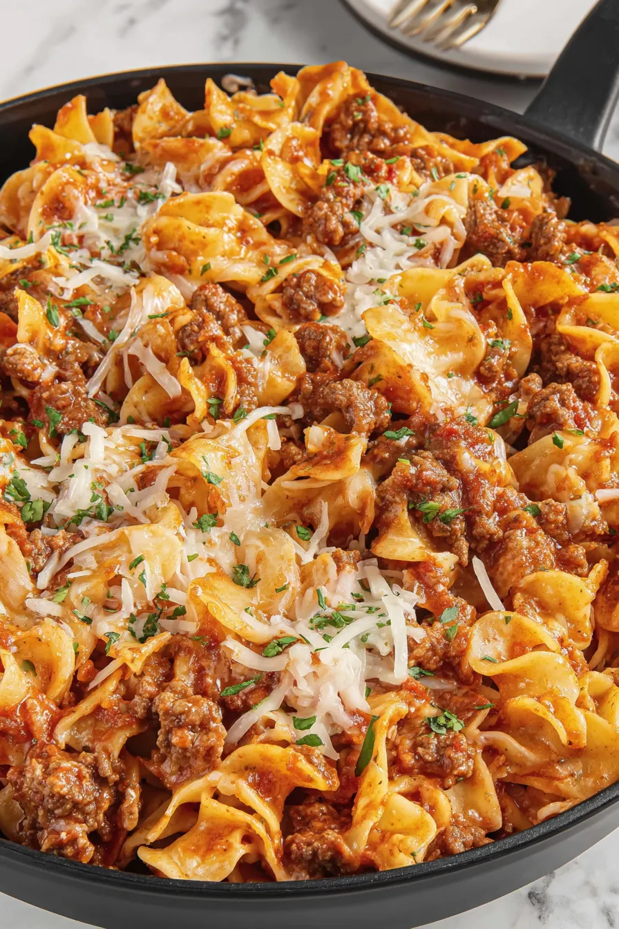 Noodle bake bubbling in a baking dish with golden melted cheese
