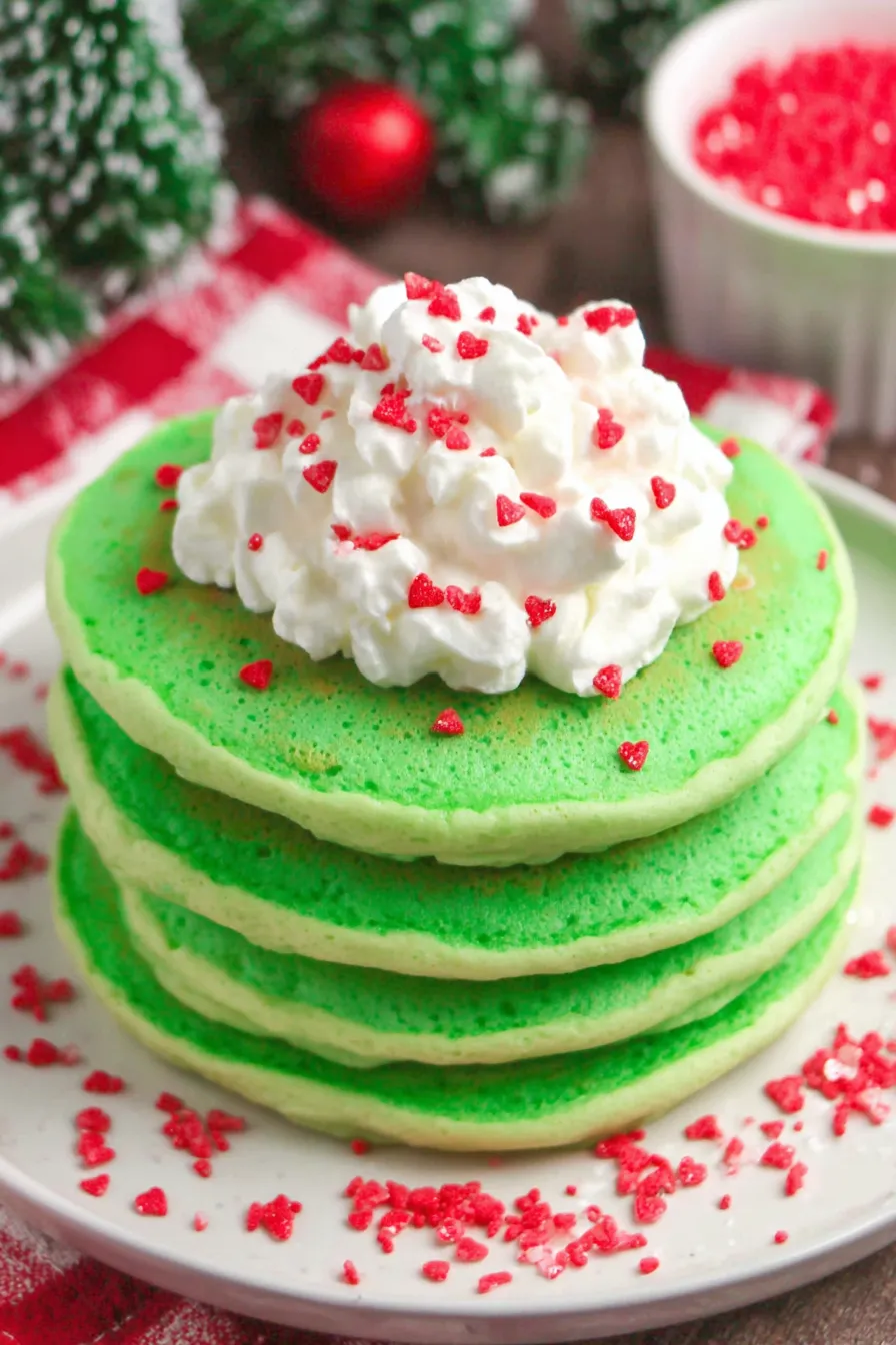Close-up of green piped whipped topping with red heart sprinkle