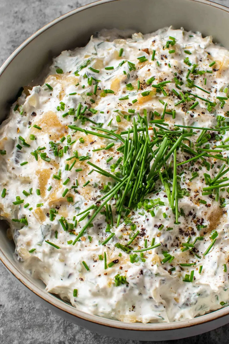 Finished French onion dip in a bowl with chives