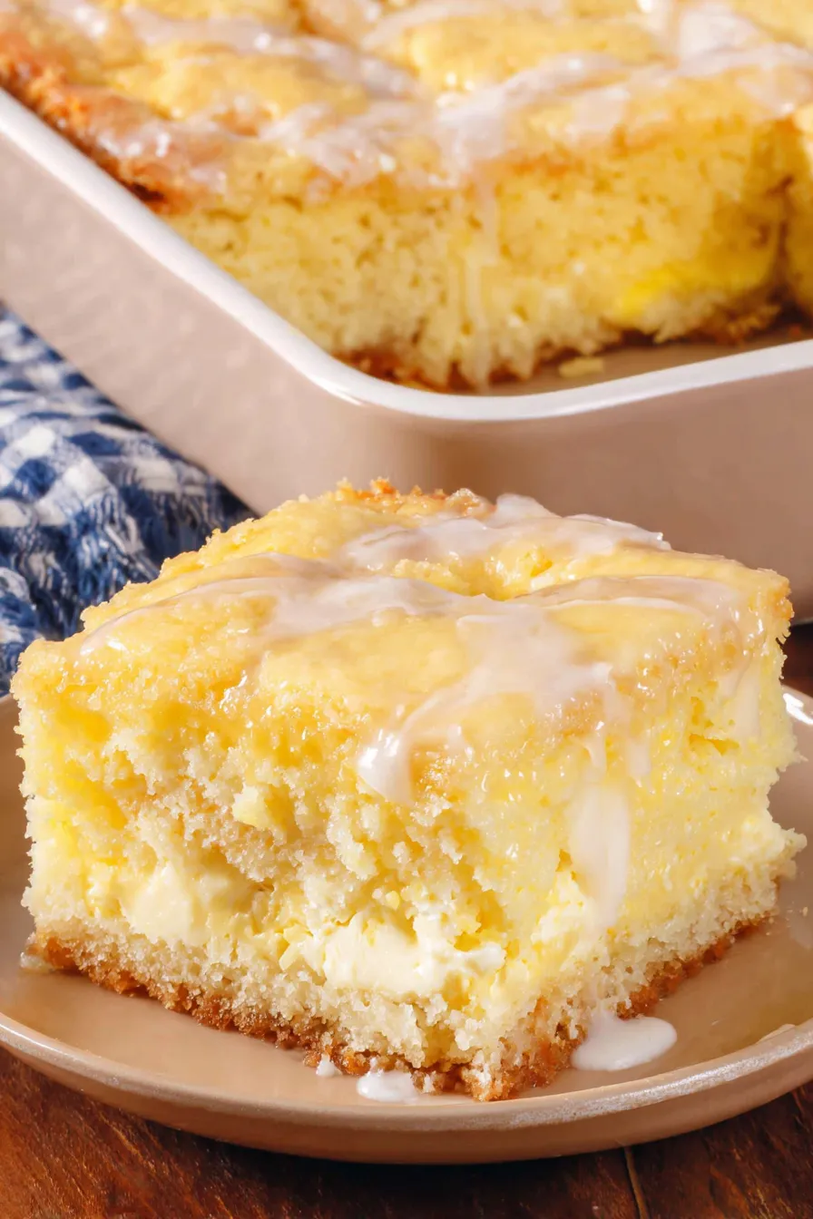 Butter cake in a 9x13 pan with cream cheese layer