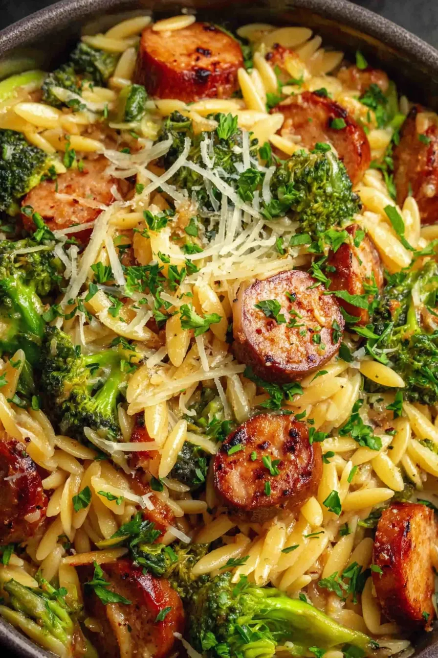 Finished chicken sausage and broccoli orzo in a pot, ready to serve