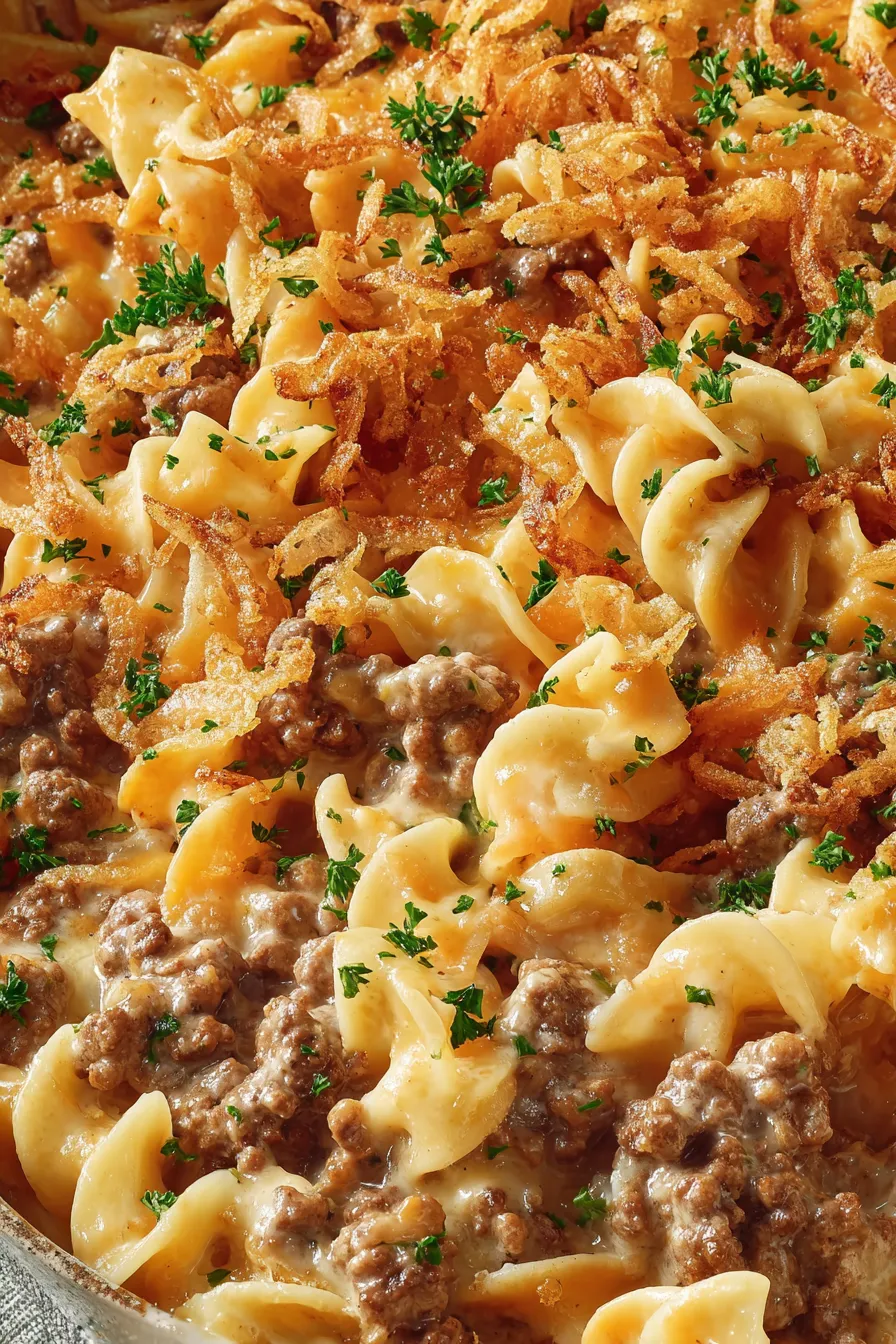 Close up of cheesy casserole with golden crust and crispy onions