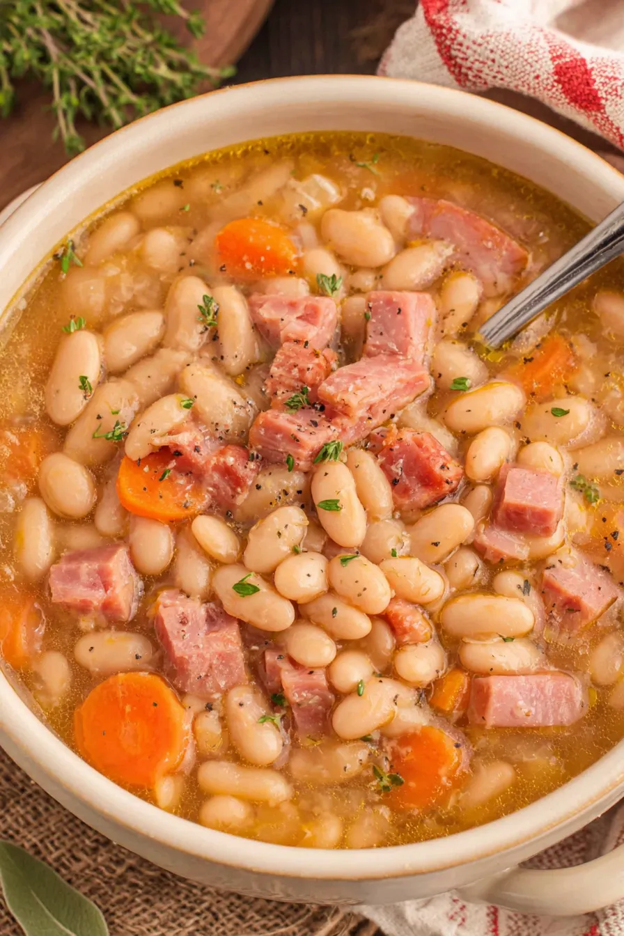 Bowl of ham and bean soup garnished with parsley