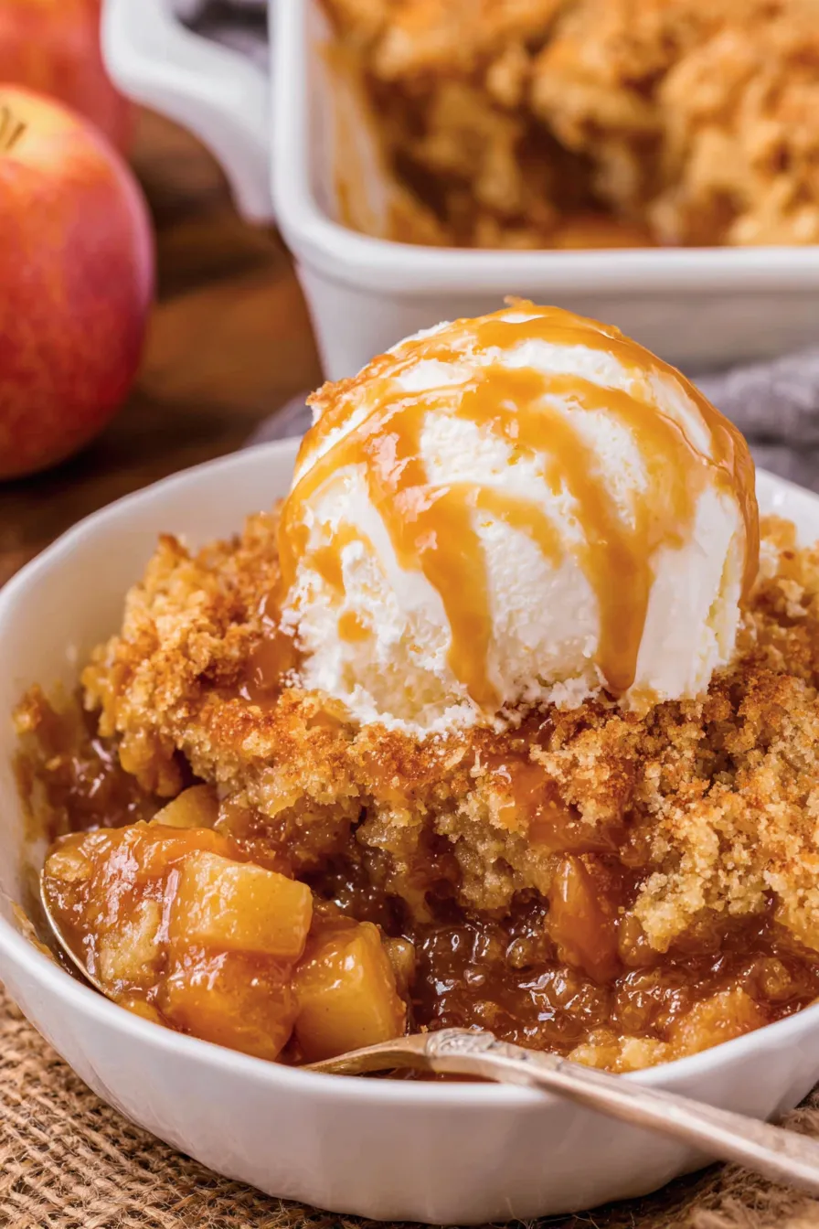 Scoop of caramel apple dump cake with vanilla ice cream