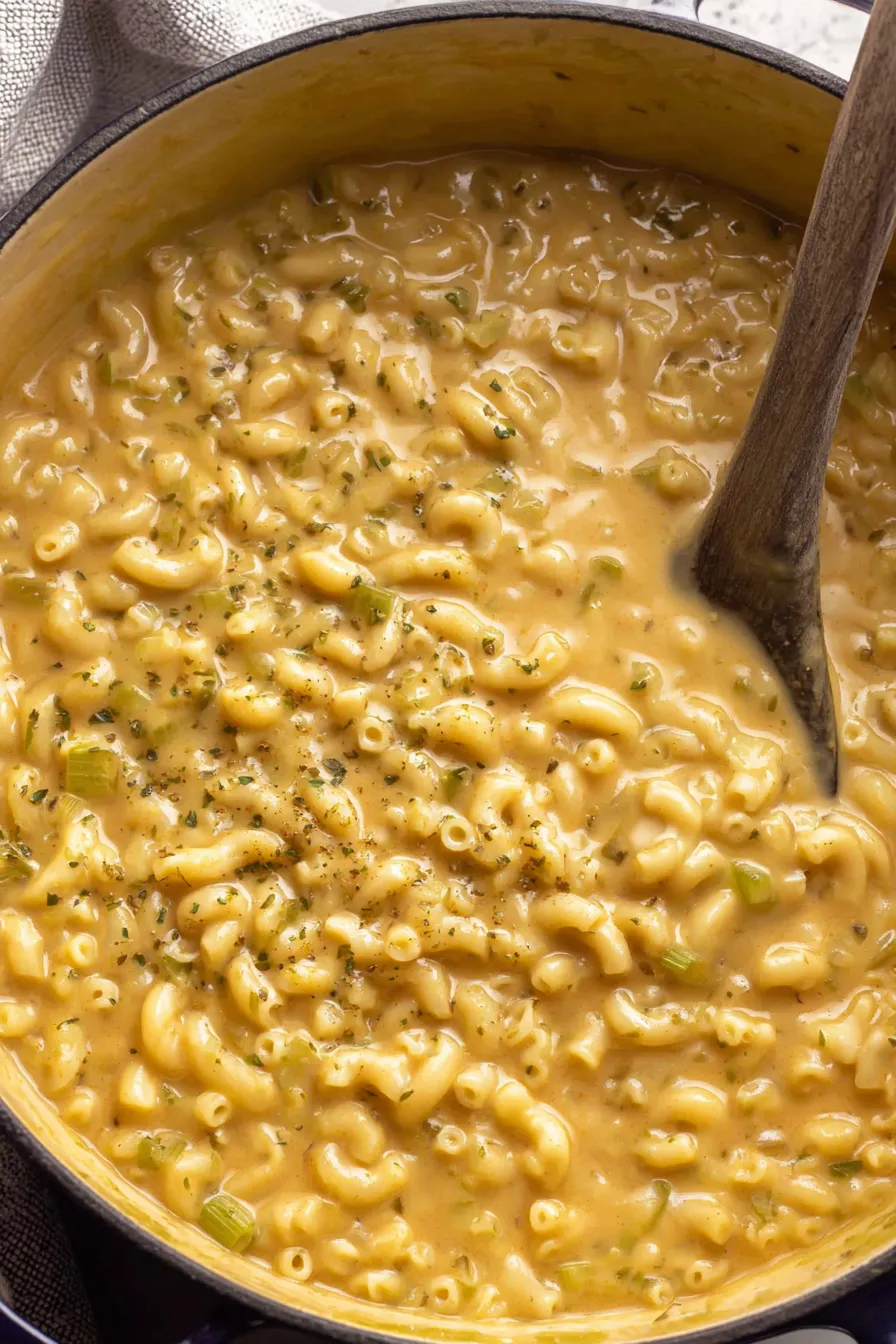Close-up of mac and cheese soup with spoon