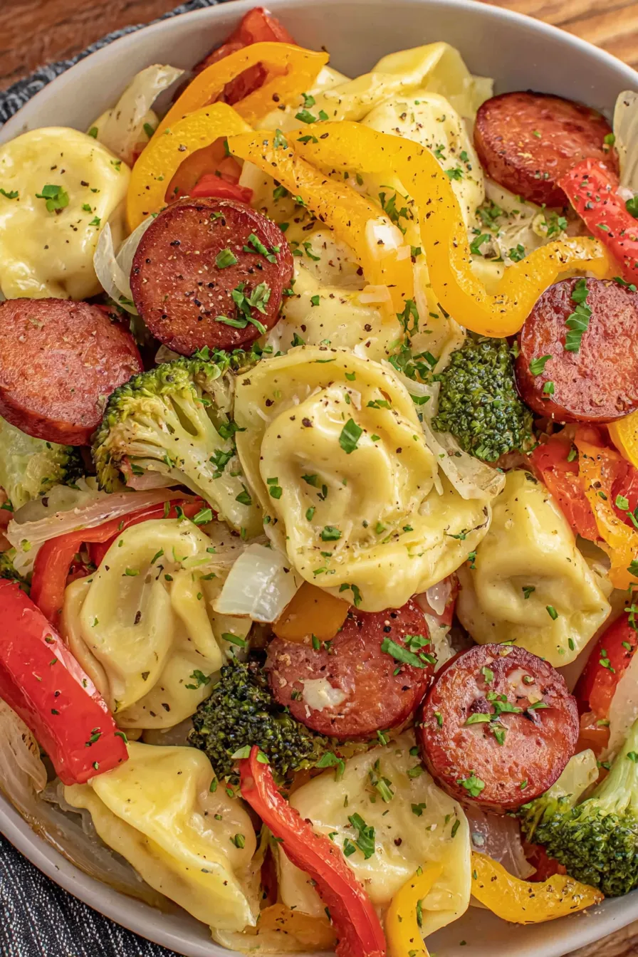 Close up of roasted pierogies and kielbasa on sheet pan
