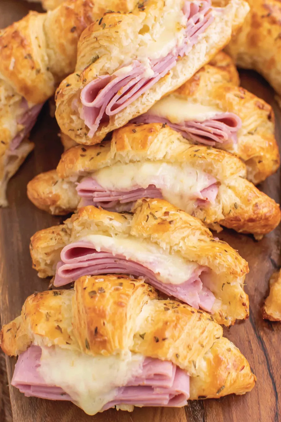 Layered ham and cheese between crescent dough ready for the oven