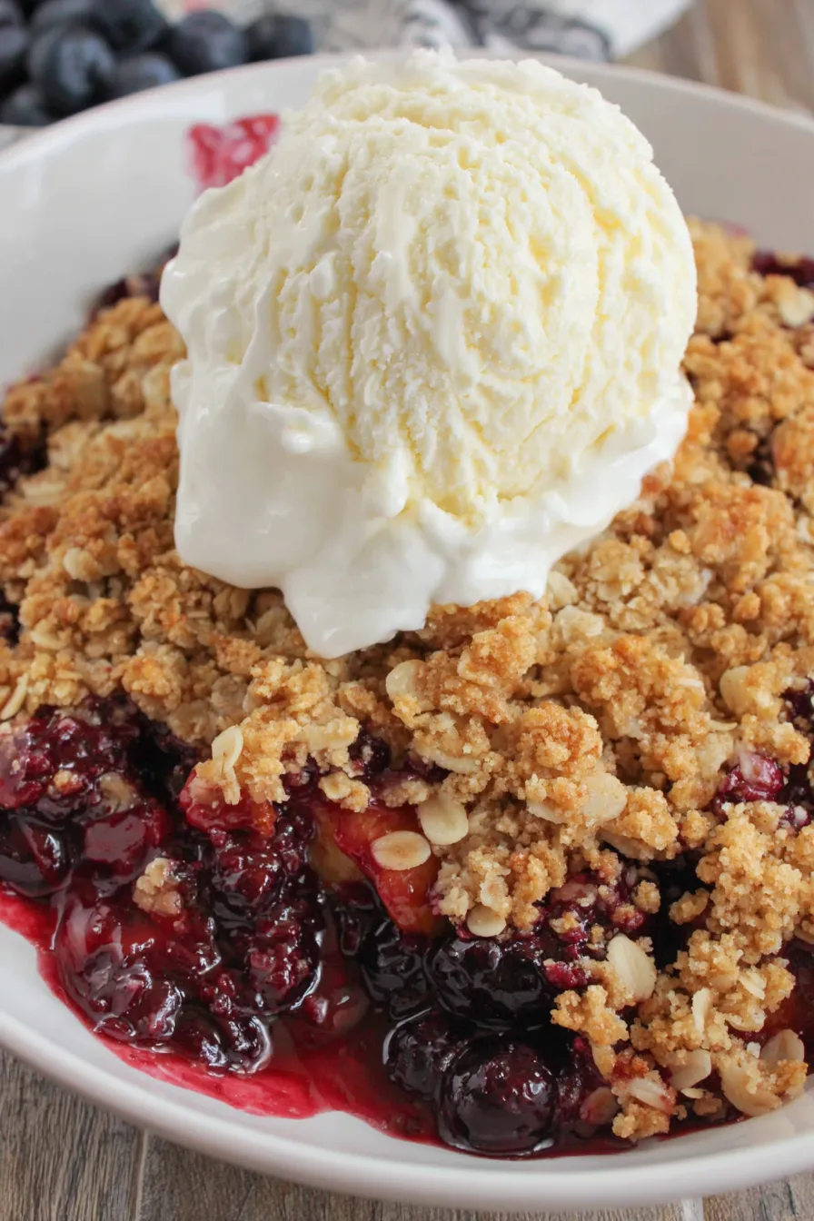 Blueberry peach crisp bubbling in a baking dish