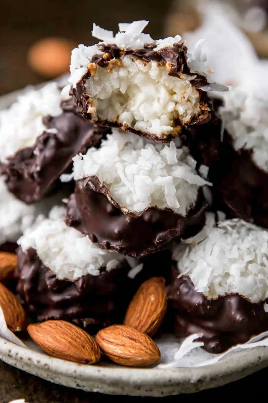 Close up of almond placed on coconut center before dipping