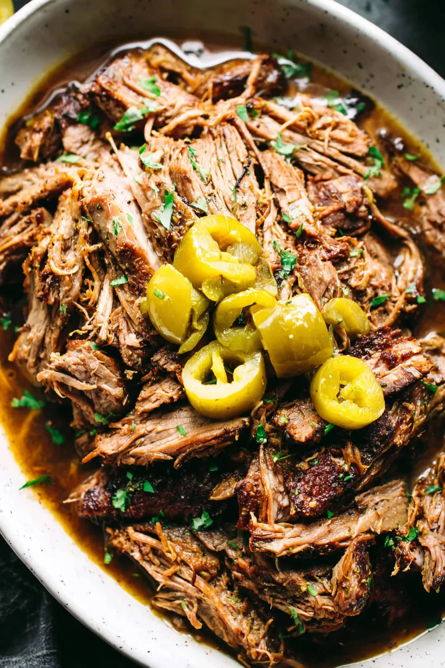 Shredded Mississippi pork on a plate ready to serve with sides