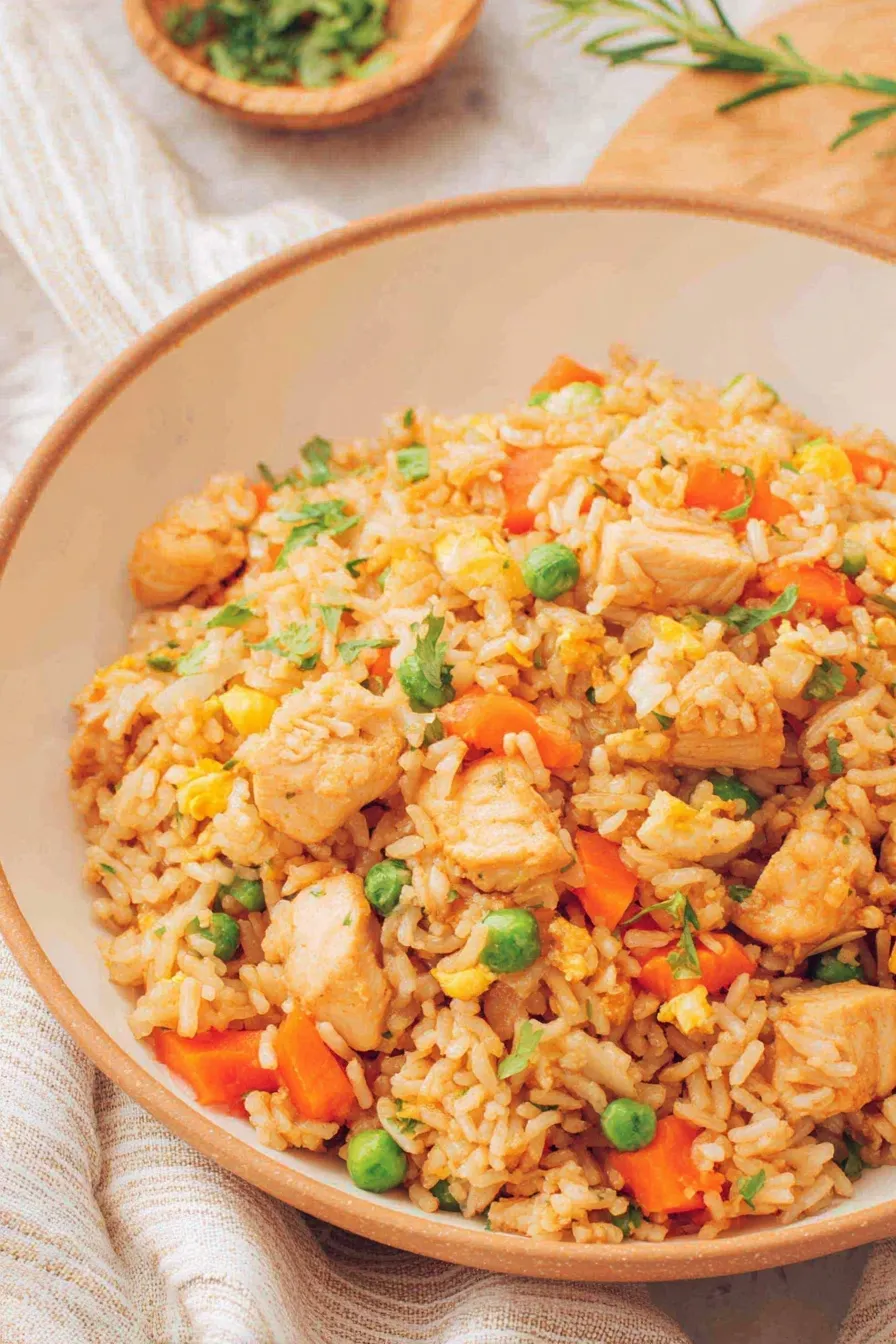 Plated chicken fried rice garnished with green onions