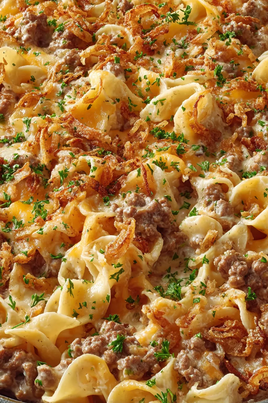 Close-up of casserole slice showing melted cheddar and onions