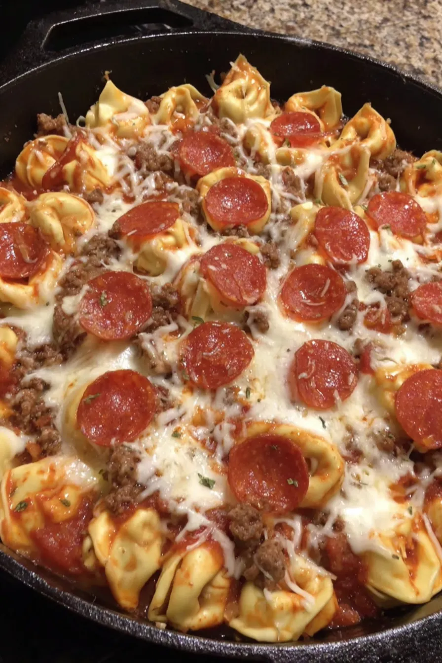 Skillet close-up of bubbling cheese and tortellini