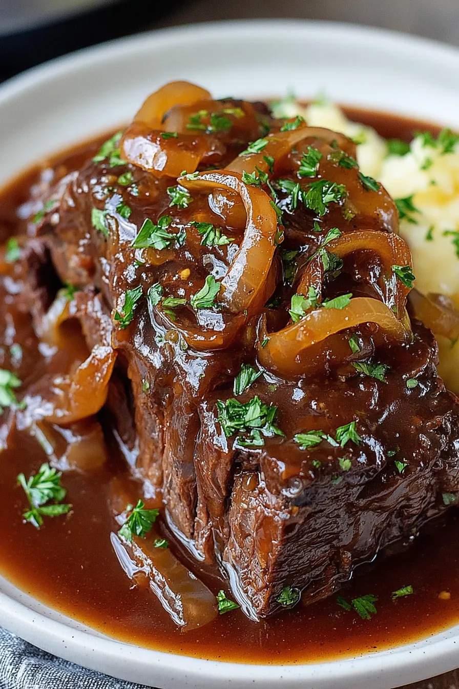Shredded pot roast served over mashed potatoes with parsley
