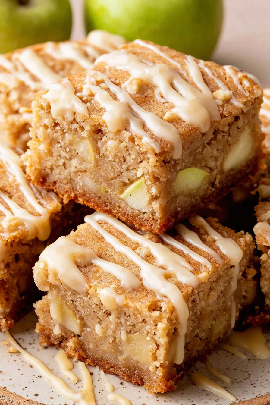 Apple blondies on a cooling rack with maple glaze