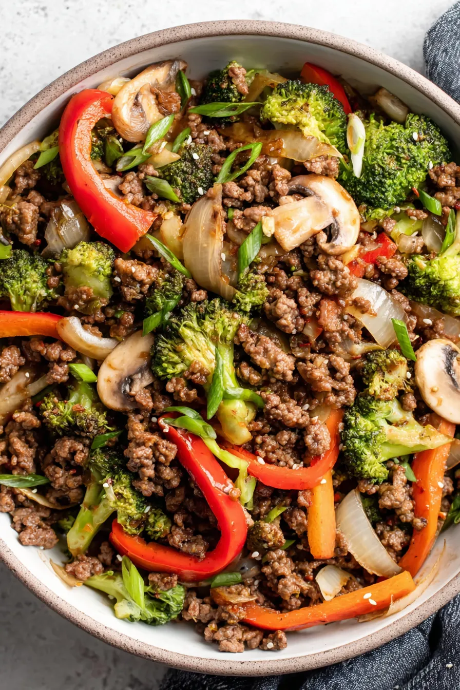 Ground beef stir fry in a skillet with vegetables