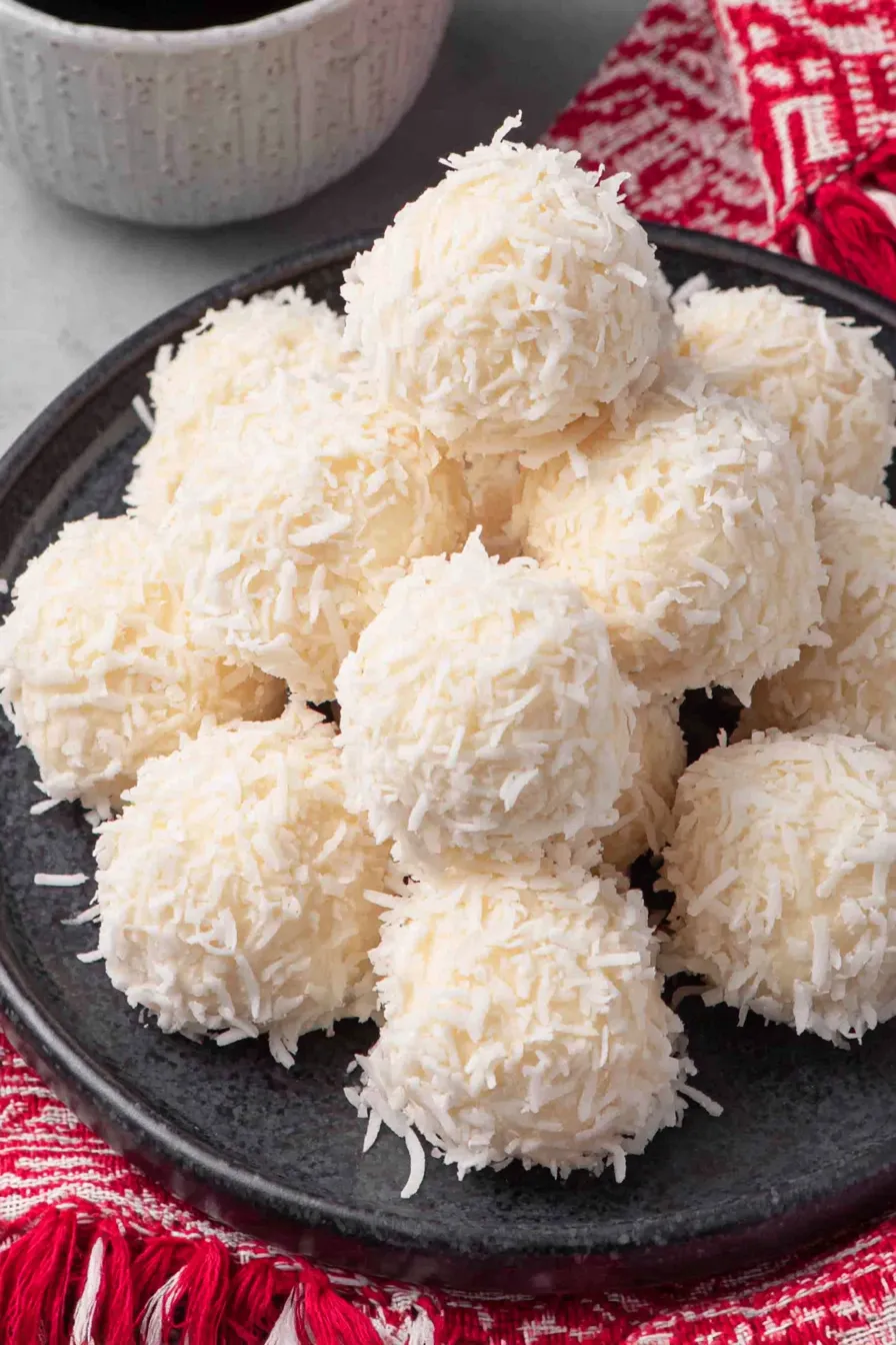 Close-up of a snowball being coated with almond bark