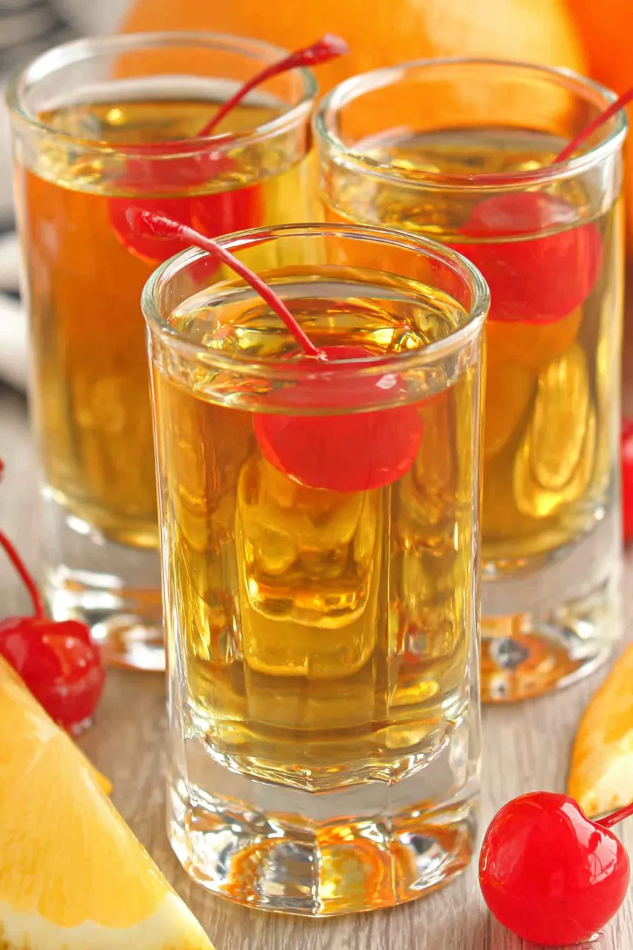 Close up of a poured whiskey shot with citrus garnish