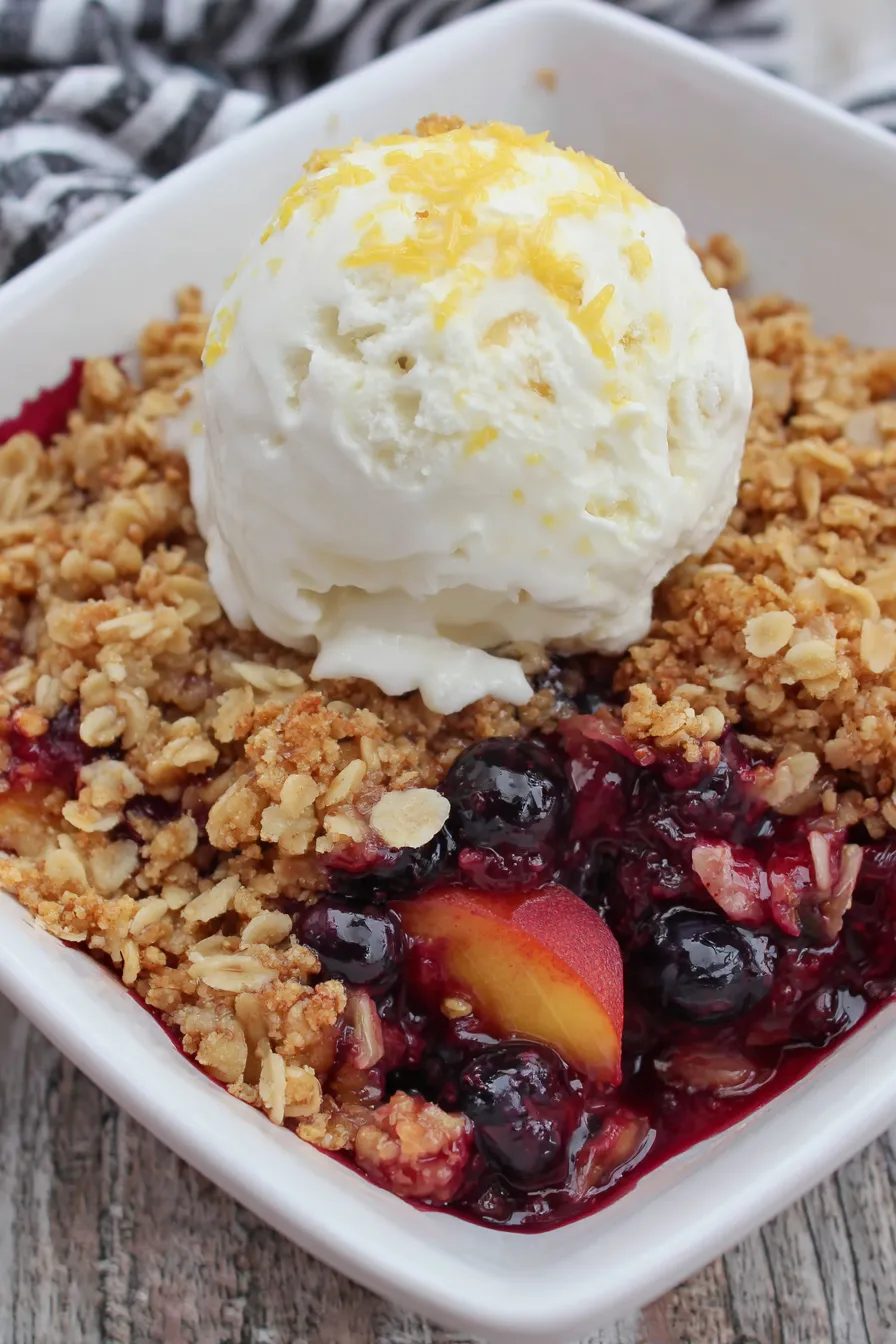 Blueberry Peach Crisp in a baking dish with a golden oat topping