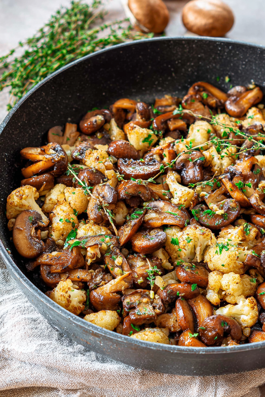Close-up of finished cauliflower and mushroom skillet with parsley