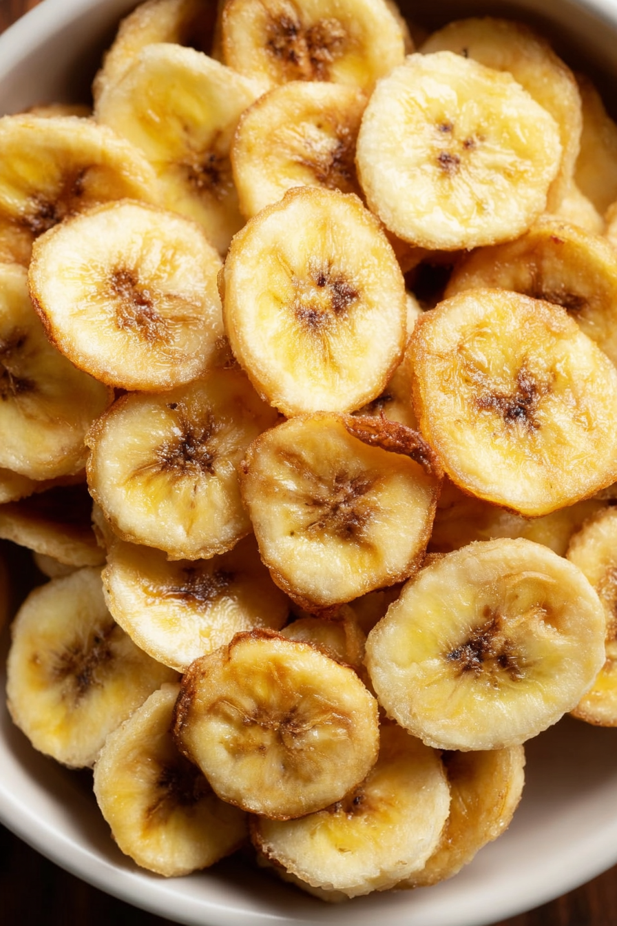 Golden crispy banana chips cooling on a rack